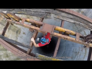 extreme on a unicycle on the edge of a 250-meter pipe