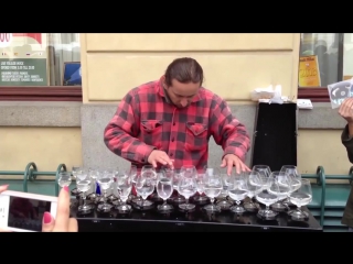 talented street musician impresses tourists with his glass playing